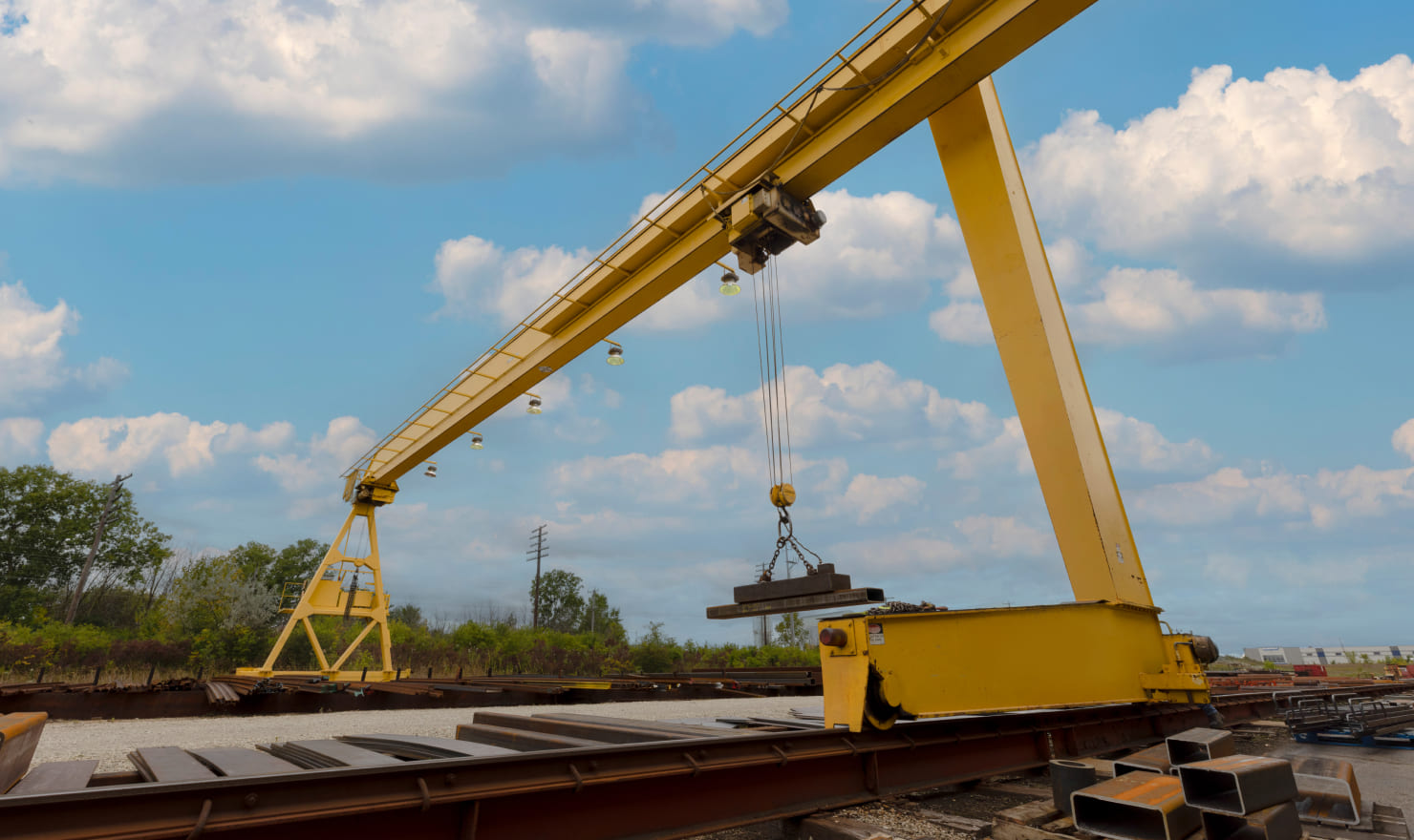 Zenar overhead crane lifting sheet metal outside facility