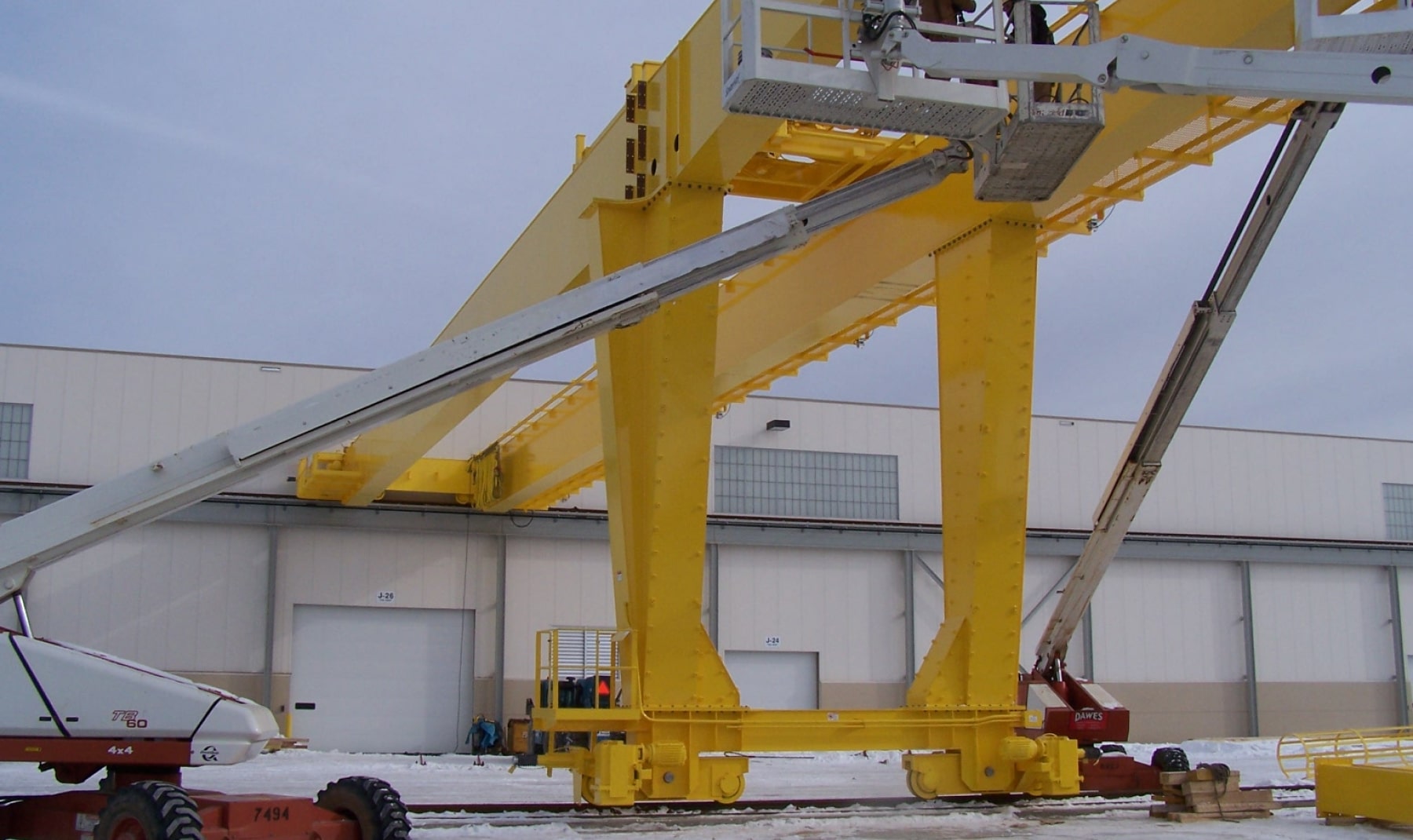 Workers outside assembling crane