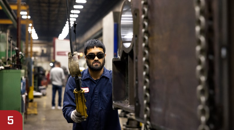 Zenar employee testing overhead crane part