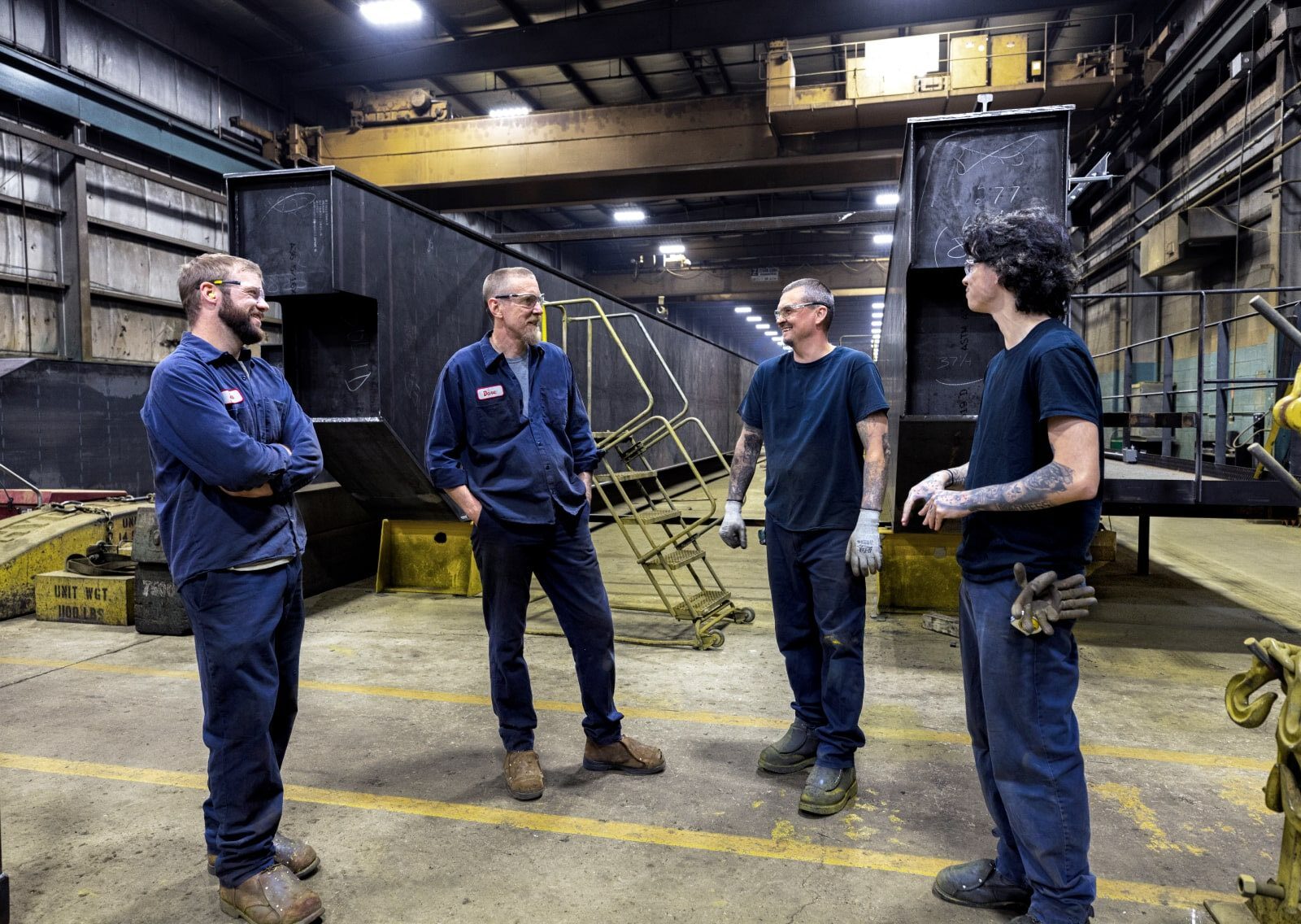 Zenar Crane employees talking inside workshop