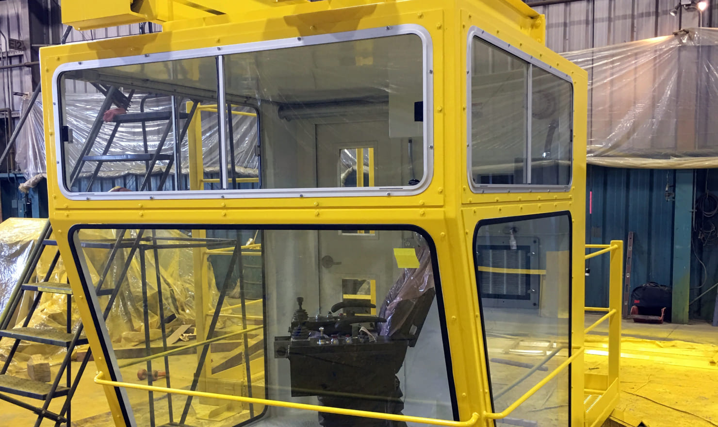 Yellow Zenar crane cab for assembly